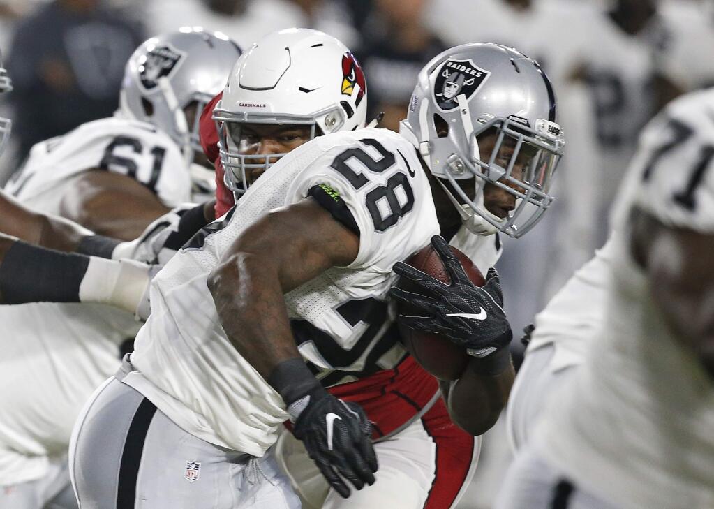 Oakland Raiders running back Latavius Murray (28) looks for running room against the Arizona Cardinals during the first half of a preseason game Friday, Aug. 12, 2016, in Glendale, Ariz. (AP Photo/Ross D. Franklin)