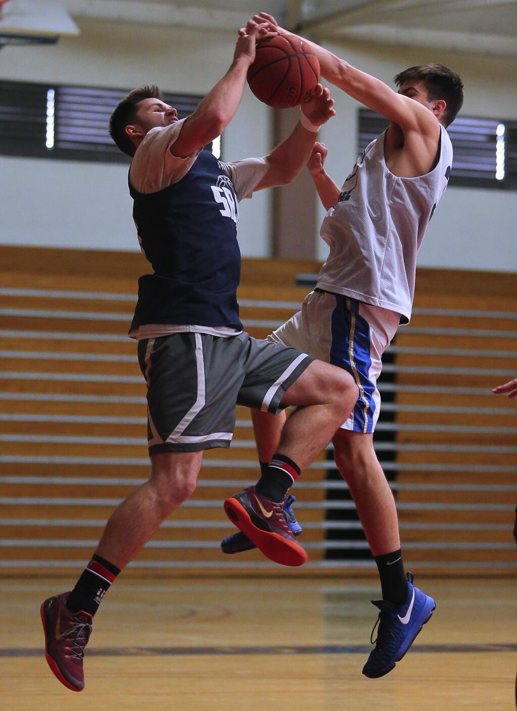 SRJC's Jon Montez left, is blocked by John McMillan as he drives to the basket during practice in Santa Rosa on Monday, February 13, 2017. (Christopher Chung/ The Press Democrat)