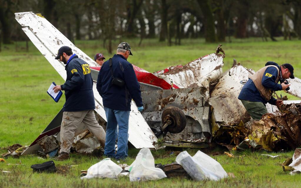 Officials with the NTSB investigate the scene of an airplane crash off Wood Road, west of Santa Rosa, on Friday, Jan. 29, 2016. Two people were killed in the crash on Thursday, Jan. 28, 2016. (JOHN BURGESS / The Press Democrat)