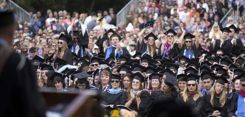 Enthusiastic members of the Class of 2016 cheer during graduation ceremonies at Sonoma State University, Saturday, May 21, 2016, in Rohnert Park, Calif. (Photo by D. Ross Cameron)