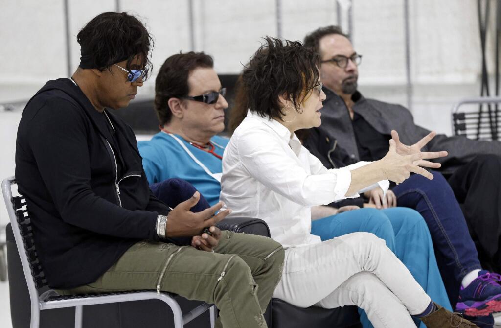 Guitarist Wendy Melvoin, center, answers a question as the original members of Prince's 1980's band, The Revolution, are interviewed Wednesday, April 19, 2017, at a studio in Minneapolis. The group, from left: bassist BrownMark, Melvoin, keyboarder Matt Fink and drummer Bobby Z. is back, preparing to kick off a spring U.S. tour with a performance Friday, the first anniversary of the Prince's death from an accidental overdose. (AP Photo/Jim Mone)