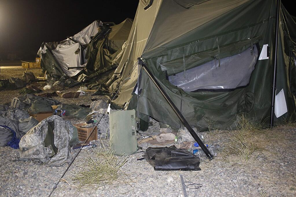 This photo provided by the U.S. Army shows a tent that was blown down by a helicopter injuring 22 people at the Fort Hunter Liggett military base in California on Wednesday, July 18, 2018. A U.S. Army UH-60 Blackhawk helicopter was landing about 9:30 p.m. when the wind from its rotor caused the tent to collapse, said Amy Phillips, public information officer at the Monterey County base. (Spc. Derek Cummings/U.S. Army via AP)