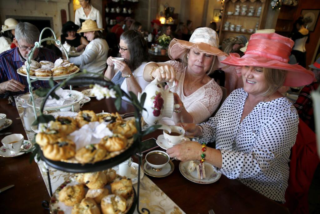 Kimberly Coenen pours tea for Andrea Christensen, right, during a Mary Poppins Holiday Tea Party at The Tudor Rose English Tea Room in Santa Rosa, on Sunday, December 17, 2017. (BETH SCHLANKER/ The Press Democrat)