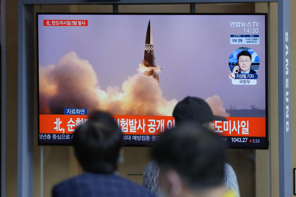 People watch a TV screen showing a news program reporting about North Korea's missiles with file image, in Seoul, South Korea, Wednesday, Sept. 15, 2021. North Korea fired two ballistic missiles into waters off its eastern coast Wednesday afternoon, two days after claiming to have tested a newly developed missile in a resumption of its weapons displays after a six-month lull. (AP Photo/Lee Jin-man)