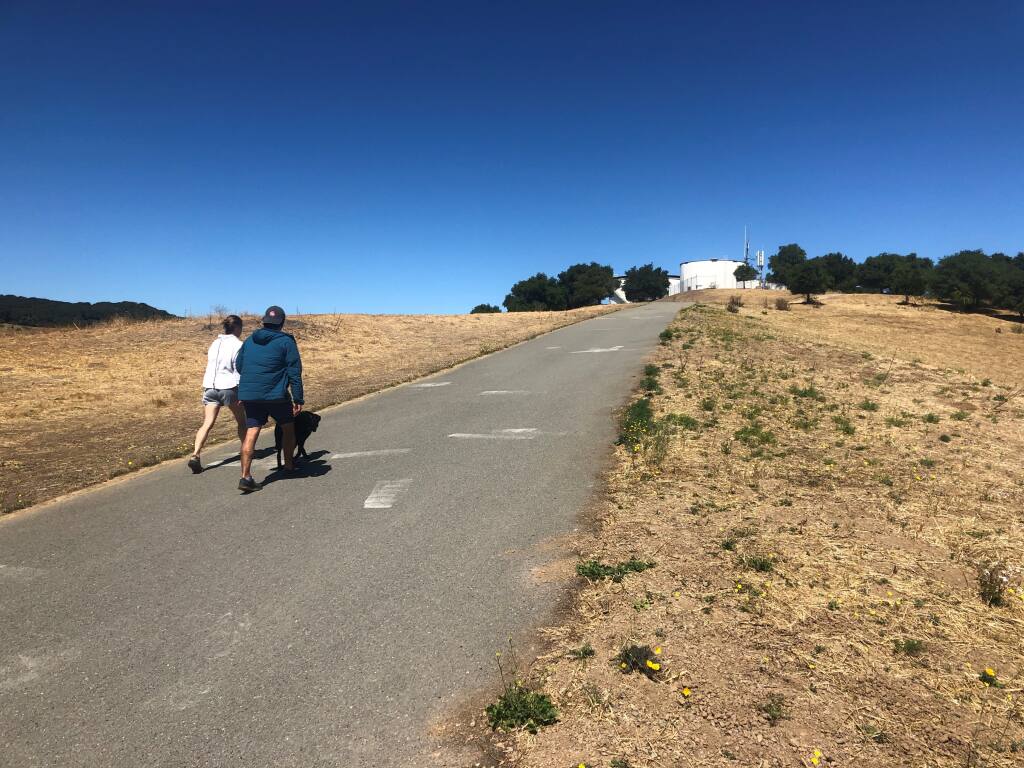 Walkers approaching the twin water towers, visible from much of downtown Petaluma. (PHOTO BY DAVID TEMPLETON)