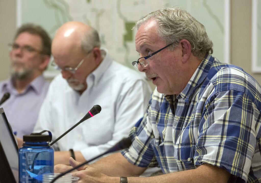 Michael Coleman, foreground, asks a question at an earlier Planning Commission meeting on April 13. Next to him is commission chair James Cribb; at left is former commissioner Bill Willers, who resigned earlier this summer over the appointment process. (Photo by Robbi Pengelly/Index-Tribune)