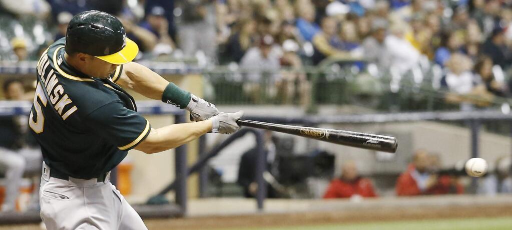 Oakland Athletics' Jake Smolinski hits a single during the sixth inning of a baseball game against the Milwaukee Brewers Wednesday, June 8, 2016, in Milwaukee. The hit was the Athletics' first of the game. (AP Photo/Morry Gash)