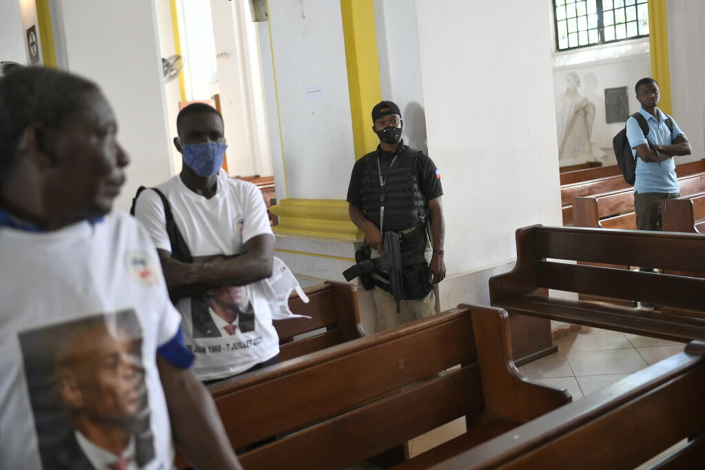 The city mayor's security guard stands by during a memorial service for slain Haitian President Jovenel Moïse in the Cathedral of Cap-Haitien, Haiti, Thursday, July 22, 2021. Moïse was killed in his home on July 7. (AP Photo/Matias Delacroix)