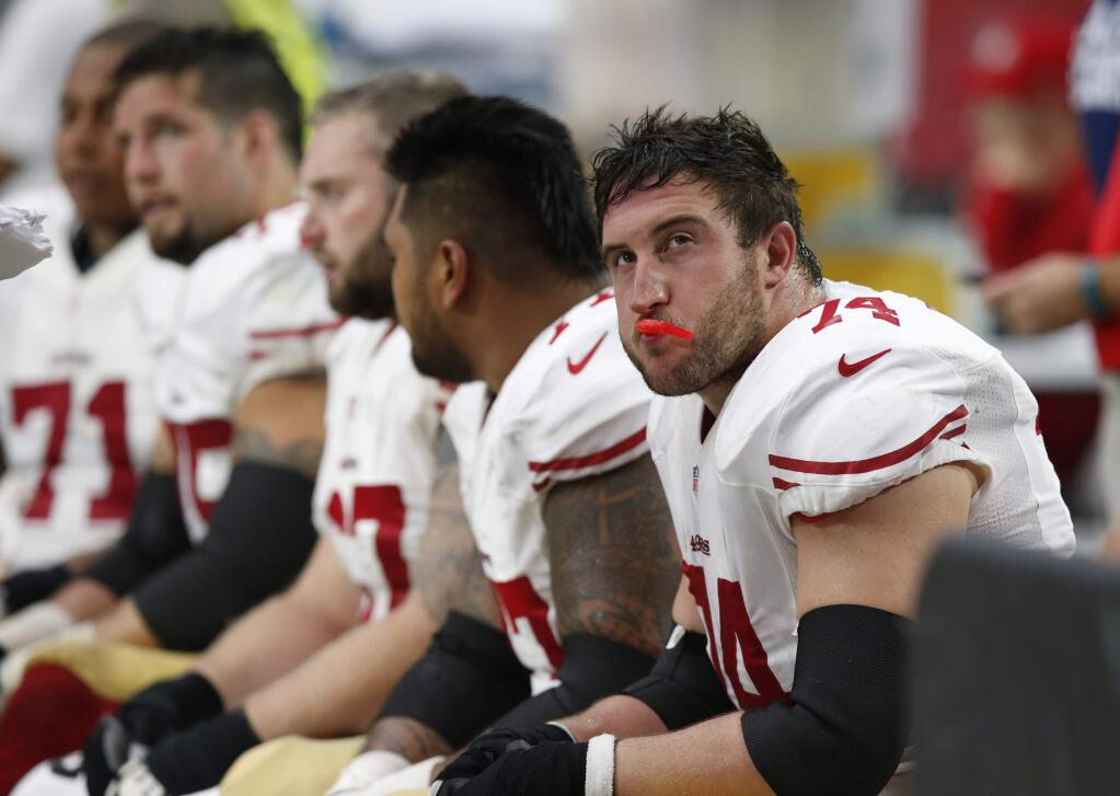 San Francisco 49ers players watch from the bench during the second half of an NFL football game against the Arizona Cardinals, Sunday, Sept. 21, 2014, in Glendale, Ariz. The Cardinals won 23-14. (AP Photo/Ross D. Franklin)