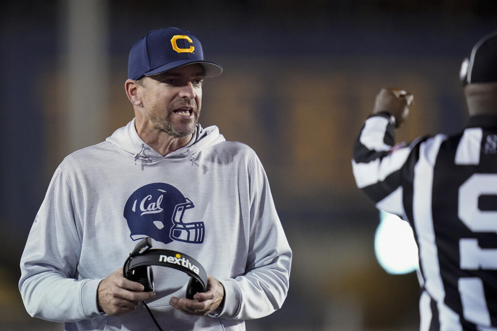 Cal coach Justin Wilcox talks to side judge Gary Reed during the second half Saturday against Washington. (Godofredo A. Vásquez / ASSOCIATED PRESS)