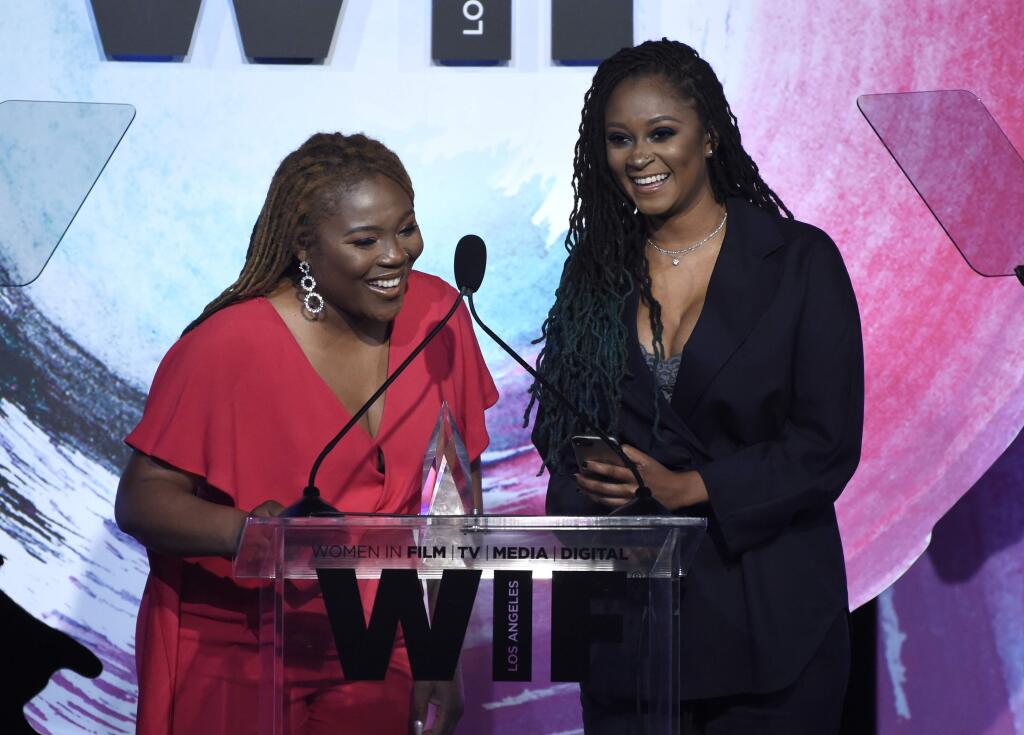 Denisea 'Blu June' Andrews, left, and Brittany Chi Coney accept the artistic excellence award at the Women In Film Crystal and Lucy Awards at the Beverly Hilton Hotel on Wednesday, June 13, 2018, in Beverly Hills, Calif. (Photo by Chris Pizzello/Invision/AP)