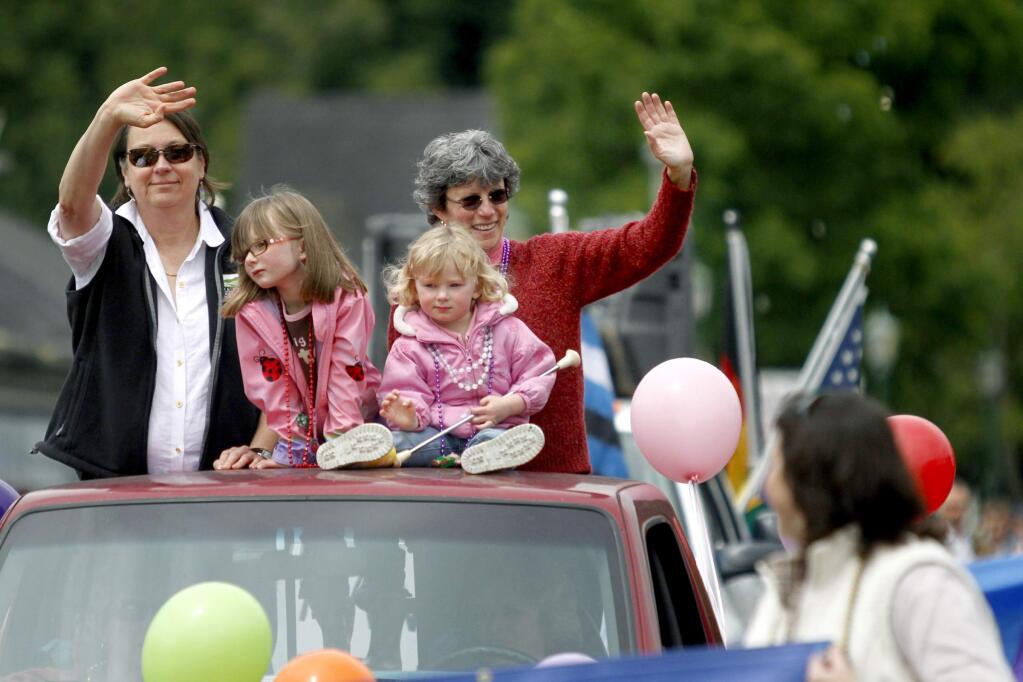 Janet Orchard, the Mayor of Cotati, left, and Jill Ravitch, the Sonoma County District Attorney, right, ride in the back of a truck with Caitlin Elward, 6, and her sister, Maddie Elward, 2, during the Sonoma County annual LGBTQI Pride Parade in Guerneville, California on Sunday, June 5, 2011. (BETH SCHLANKER/ The Press Democrat)