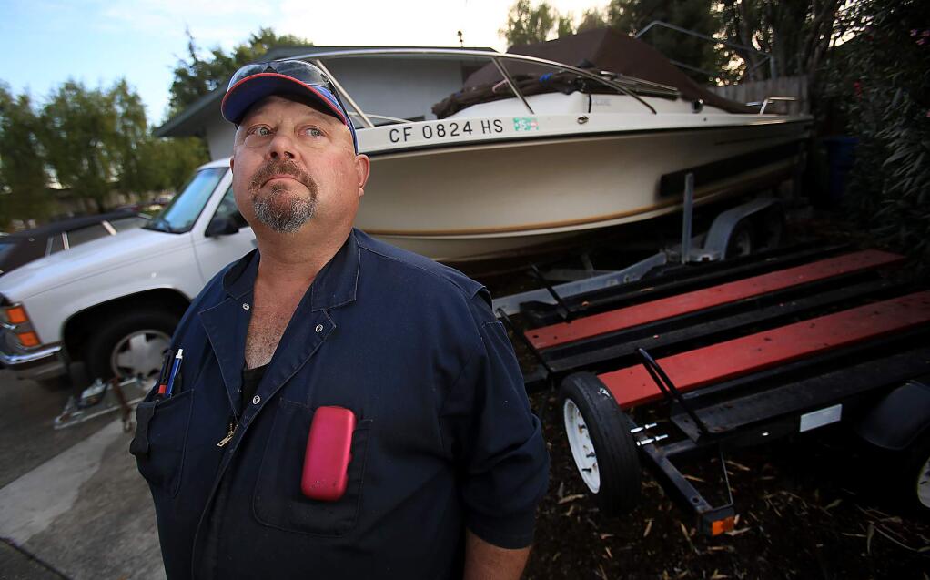 Dodd Stange of Petaluma has been told to move his boat from his front side yard, Thursday Nov. 5, 2015. (Kent Porter / Press Democrat ) 2015