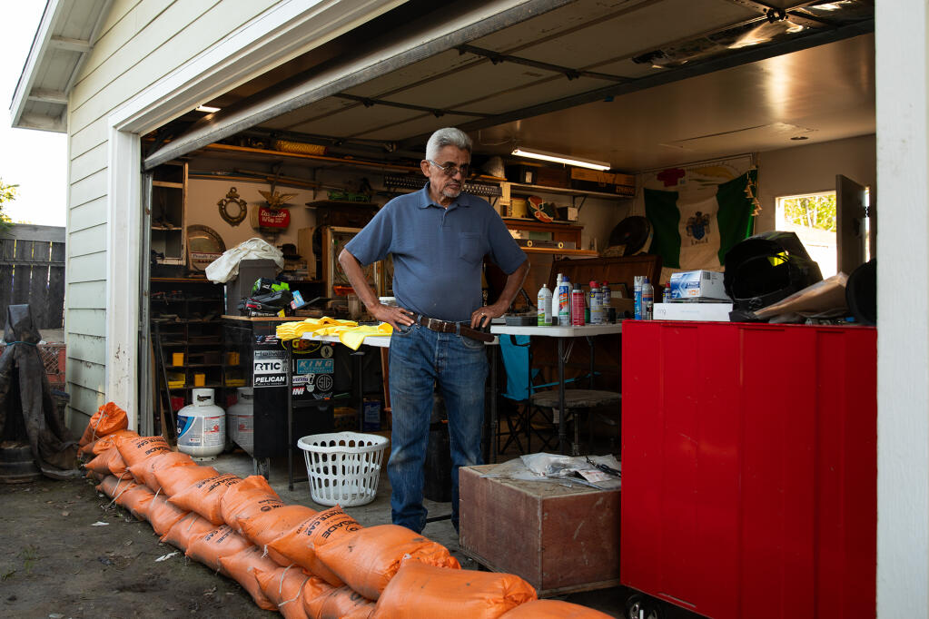 Gregory Montoya in his garage where he stores antique items that were severely damaged by recent floods in the Southcrest neighborhood of San Diego. March 8, 2024. Photo by Adriana Heldiz, CalMatters