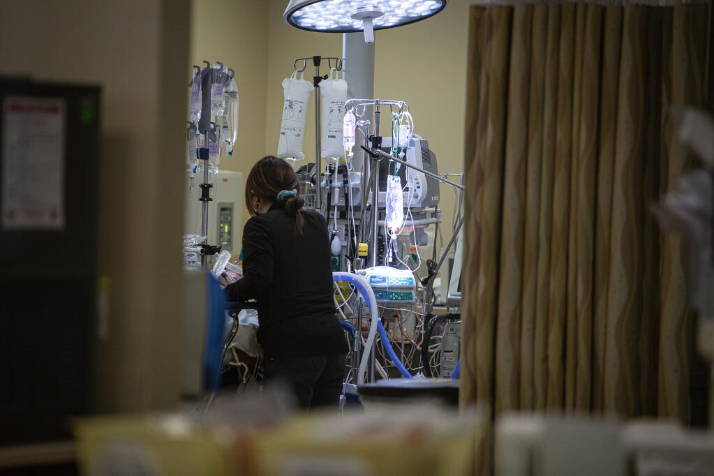 A nurse checks on a patient in the Emergency Room unit of Hazel Hawkins Memorial Hospital in Hollister on March 30, 2023. Photo by Larry Valenzuela, CalMatters/CatchLight Local