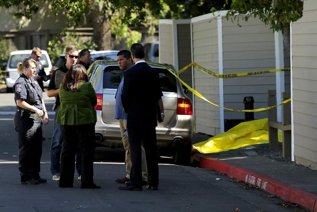 Authorities investigate the scene of a fatal shooting at a townhouse complex off West Steele Lane in Santa Rosa on Wednesday, July 29, 2015. (JOHN BURGESS/ PD)