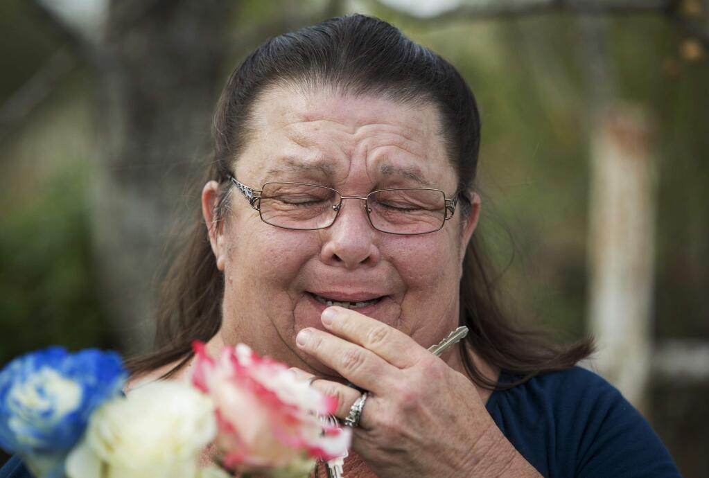 Belinda McLaurin, of La Vernia, Texas, breaks down while visiting the scene of a mass shooting at First Baptist Church in Sutherland Springs, Texas, on Tuesday, Nov. 7, 2017. McLaurin said she is a former member of the congregation, and she knows victims of the shooting. (Jay Janner/Austin American-Statesman via AP)