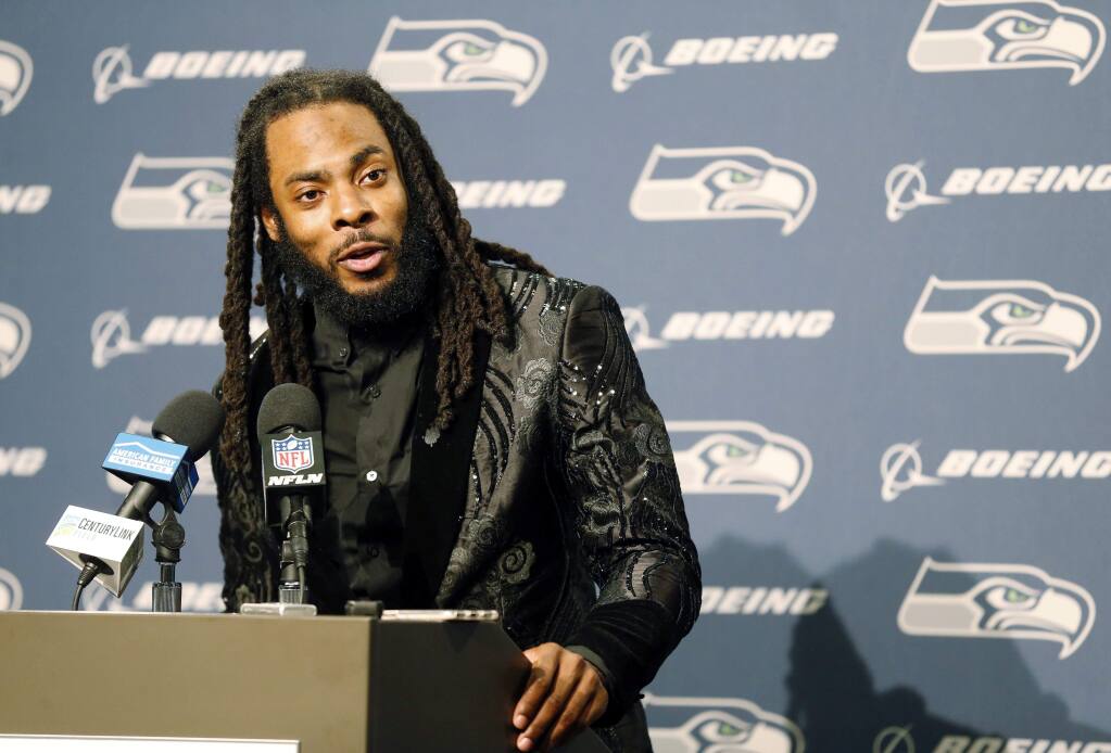 In this Oct. 29, 2017, file photo, Seattle Seahawks cornerback Richard Sherman talks to reporters during a postgame news conference following a game against the Houston Texans, in Seattle. Sherman signed a three-year deal with the San Francisco 49ers on Sunday, March 11, 2018, two days after being released by the rival Seahawks. (AP Photo/Stephen Brashear, File)