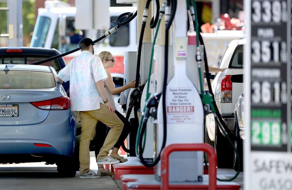 Customers buy fuel at the Safeway gas station in Santa Rosa, Tuesday July 14, 2015 in Santa Rosa. (Kent Porter / Press Democrat) 2015