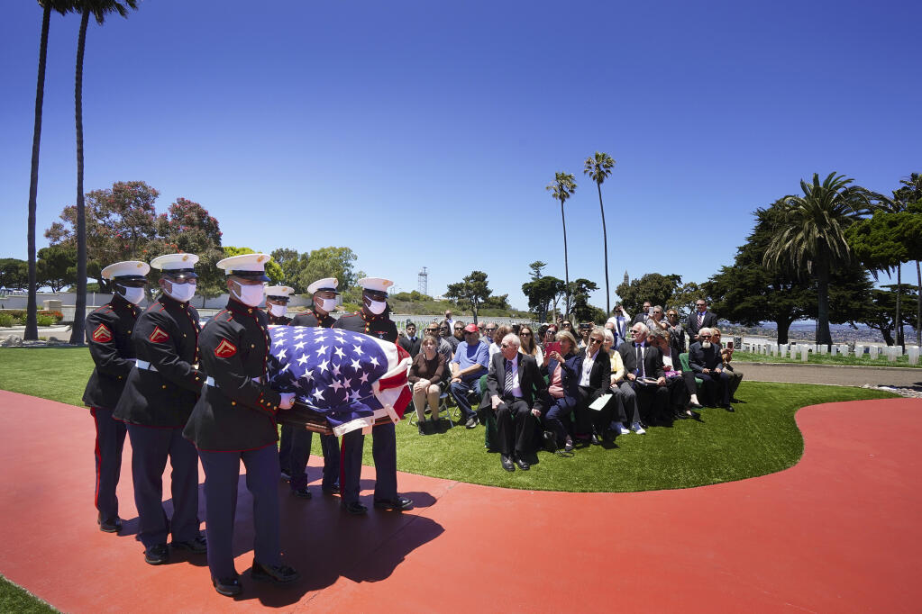 A military honor guard escorts the casket of Marine Corps, Pfc. John Franklin Middleswart for a full military honors at Fort Rosecrans National Cemetery, on Tuesday, June 8, 2021 in San Diego. Eighty years after he died in the attack on Pearl Harbor and just months after his remains were finally identified, the California Marine has been laid to rest with full military honors. About 50 people attended the ceremony Tuesday in his hometown of San Diego, the Union-Tribune reported. (Nelvin C. Cepeda/The San Diego Union-Tribune via AP)