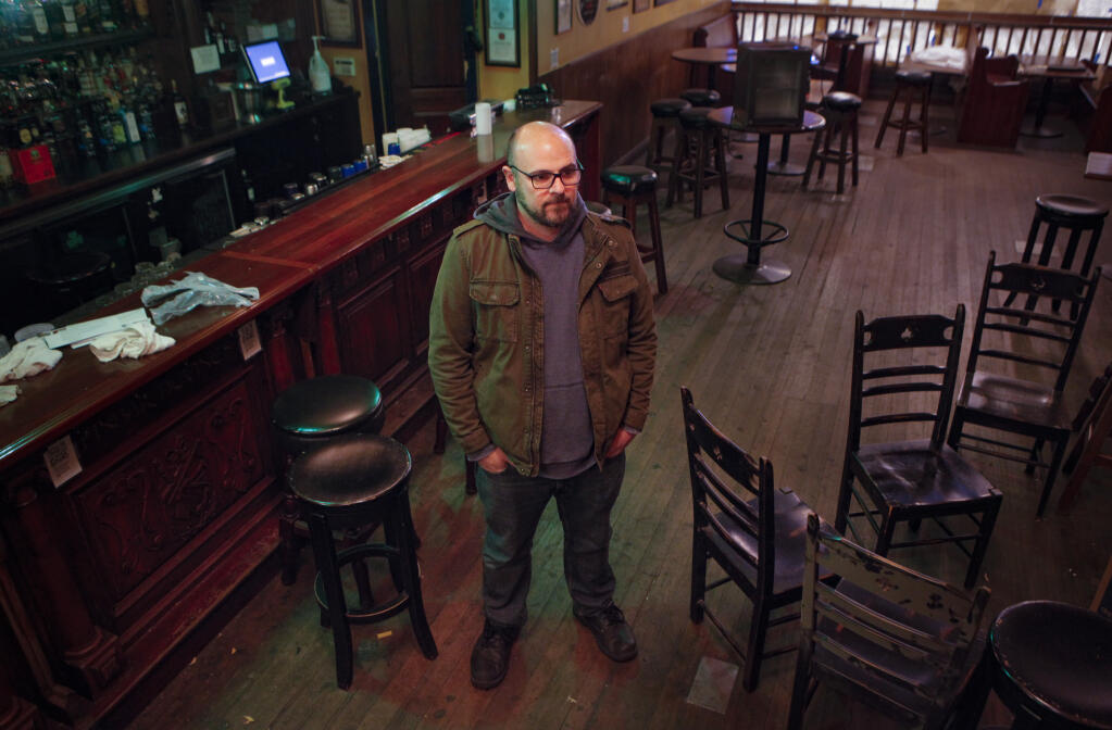 Joe Pelleriti, owner of Maguire’s Irish Pub stands in the middle of his empty restaurant-bar which has been shuttered since the shelter-in-place. The bar will soon close. (CRISSY PASCUAL/ARGUS-COURIER STAFF)