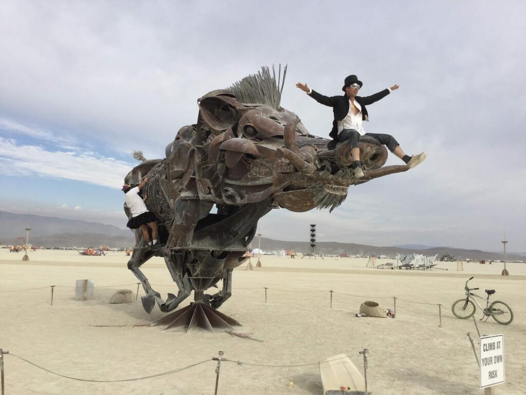 Scenes from Burning Man, Tuesday, Aug. 30, 2016. Already a huge hit is “Lord Snort” by Bryan Tedrick of Glen Ellen. Burning Man participants climb onto and rotate the massive boar, which is made of scrap and recycled metal. Tedrick's previous Burning Man sculptures include “The Coyote” and “Spread Eagle.” (Chris Smith / Press Democrat)