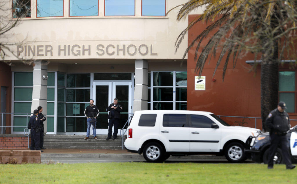Police stand outside Piner High School after the school was placed on lockdown after a report of a suspicious person near the school in Santa Rosa, on Thursday, March 1, 2018. (BETH SCHLANKER/ The Press Democrat)