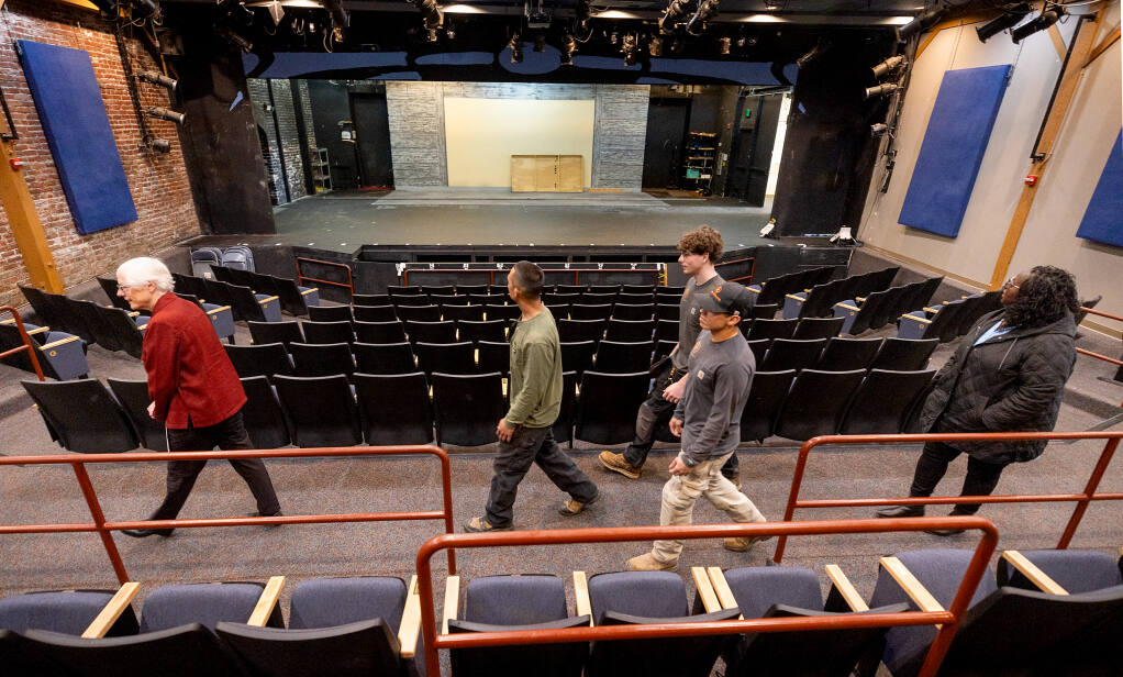 Dorothy Beattie, left, leads business owners Marcus Hernandez and Christopher Hernandez and NexGen Trades Academy founder Letitia Hanke on a tour through the repairs needed at the 6th Street Playhouse in Santa Rosa, Monday, Jan. 8, 2024. (John Burgess / The Press Democrat)