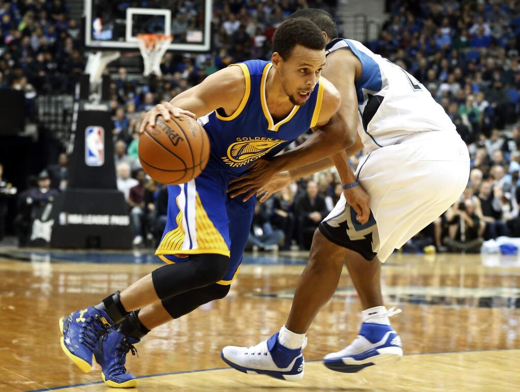 Golden State Warriors' Stephen Curry, left, drives around Minnesota Timberwolves' Andre Miller during the second half Thursday, Nov. 12, 2015, in Minneapolis. Curry led all scorers with 46 points as the Warriors won 129-116. (AP Photo/Jim Mone)