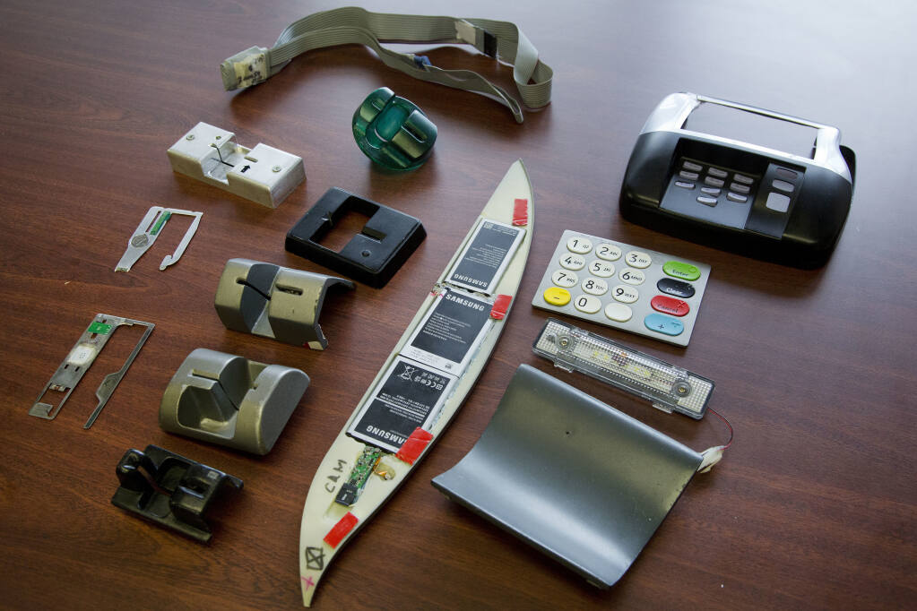 In this April 18, 2018 photo, tools used to skim information from credit cards are displayed at the office of the New York Police Department's Financial Crimes Task Force. The U.S. Secret Service says more than $1 billion is stolen from U.S. consumers each year by credit card skimmers, money that funds organized crime and which is usually passed back to consumers through higher fees. (AP Photo/Mark Lennihan)