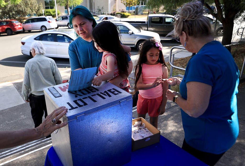 At the Sonoma County Registrar of Voters, Tiffany Blake brings daughters, Indy, 3, and Maeven, 7,  to drop off Blake's ballots, Tuesday, June 7, 2022 in Santa Rosa. (Kent Porter / The Press Democrat) 2022