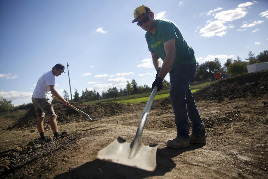 Greg Watts, right, and Andrew Taylor work to build a pump track at Northwest Community Park on Tuesday, Oct. 4, 2016 in Santa Rosa. (BETH SCHLANKER/ The Press Democrat)