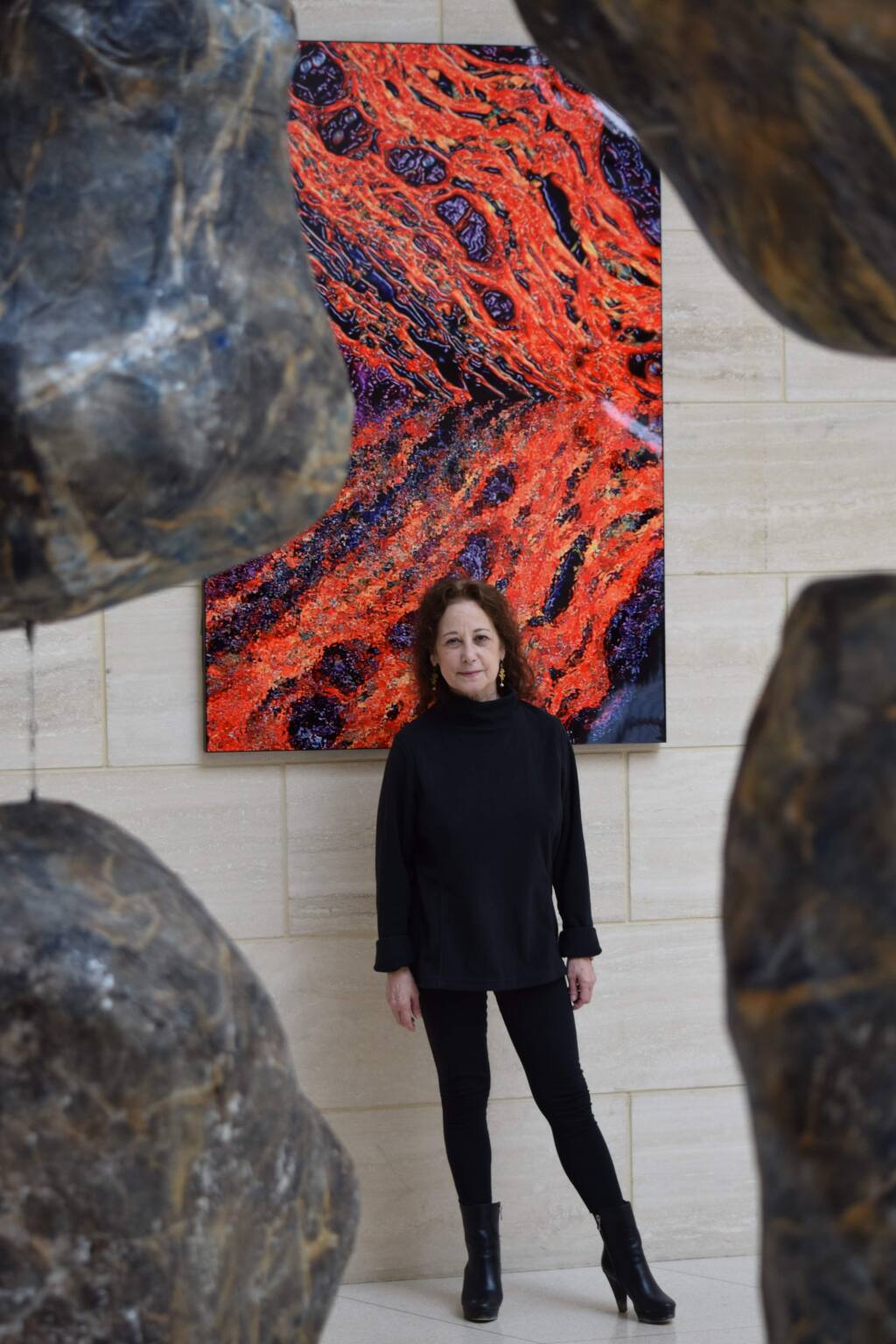 Judy Campisi, Ph.D., co-founder of Novato-based Unity Biotechnology, studies senescent cells and drugs to kill them. The Buck Institute for Age Research art behind her is collagen, enlarged.