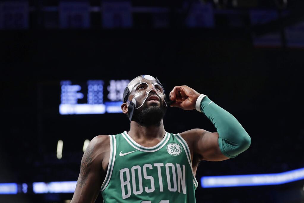 The Boston Celtics' Kyrie Irving adjusts his mask during the second half of the team's game against the Brooklyn Nets on Tuesday, Nov. 14, 2017, in New York. The Celtics won 109-102. (AP Photo/Frank Franklin II)