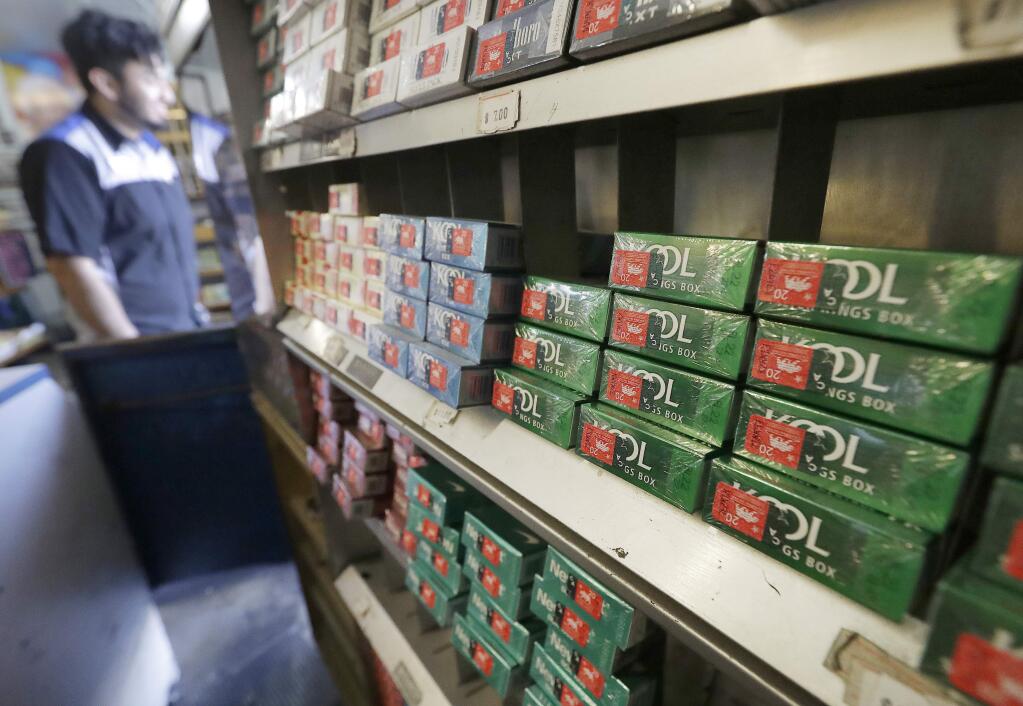 FILE - This May 17, 2018 file photo shows packs of menthol cigarettes and other tobacco products at a store in San Francisco. On Thursday, May 15, 2018, FDA Commissioner Dr. Scott Gottlieb pledged to ban menthol from cigarettes, in what could be a major step to further push down U.S. smoking rates. (AP Photo/Jeff Chiu)