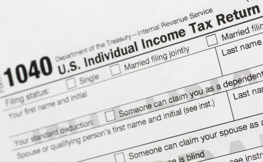 FILE - This July 24, 2018, file photo shows a portion of the 1040 U.S. Individual Income Tax Return form. The Trump administration is working on plans to delay the April 15 federal tax deadline for most individual taxpayers as well as small businesses. Treasury Secretary Steven Mnuchin told Congress on Wednesday, March 11, 2020, that the administration is 'looking at providing relief to certain taxpayers and small businesses who will be able to get extensions on their taxes.' (AP Photo/Mark Lennihan, File)
