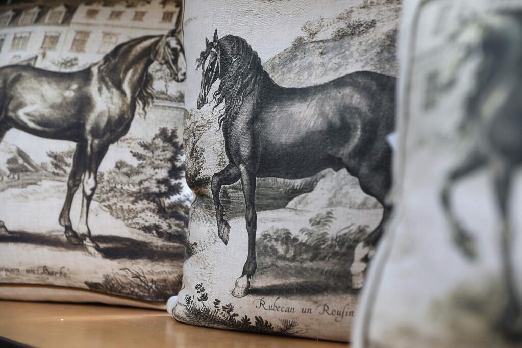 Pillows depicting horses are a popular item produced by Dallas A. Saunders.(Christopher Chung/ The Press Democrat)