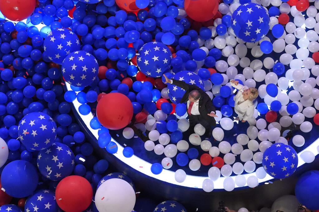 Democratic presidential nominee Hillary Clinton and her running mate Democratic vice presidential nominee Sen. Tim Kaine, D-Va., walk through a sea of balloons at the conclusion of the Democratic National Convention in Philadelphia , Friday, July 29, 2016. (AP Photo/Mark J. Terrill)