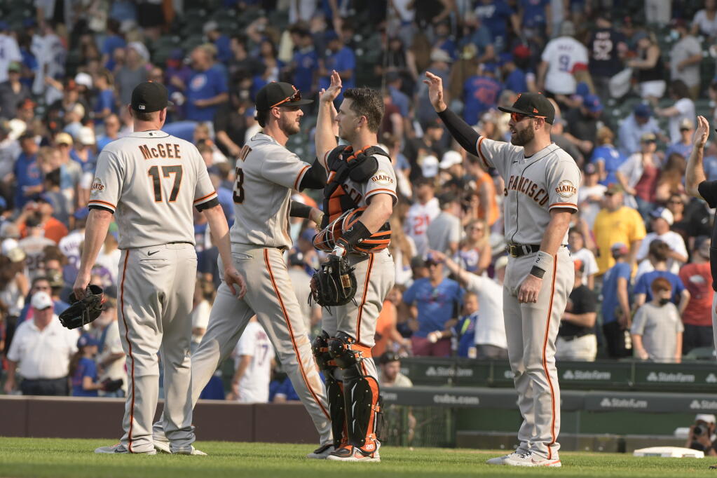 San Francisco Giants players celebrate their win over the Chicago Cubs, Sunday, Sept. 12, 2021, in Chicago. (AP Photo/Mark Black)