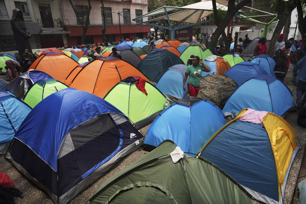 FILE - Haitian migrants camp out at the Giordano Bruno plaza in Mexico City, May 18, 2023. The group was staying at a shelter in Mexico City on their way north but were forced to make camp at the park after the shelter closed. (AP Photo/Marco Ugarte, File)