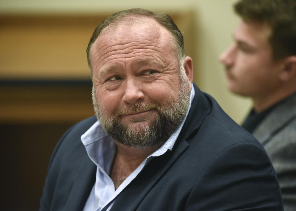 FILE - Infowars founder Alex Jones appears in court to testify during the Sandy Hook defamation damages trial at Connecticut Superior Court in Waterbury, Conn., on Thursday, Sept. 22, 2022. Jones and his company have been ordered to pay an extra $473 million to families and an FBI agent for calling the 2012 Sandy Hook school shooting a hoax. (Tyler Sizemore/Hearst Connecticut Media via AP, Pool, File)