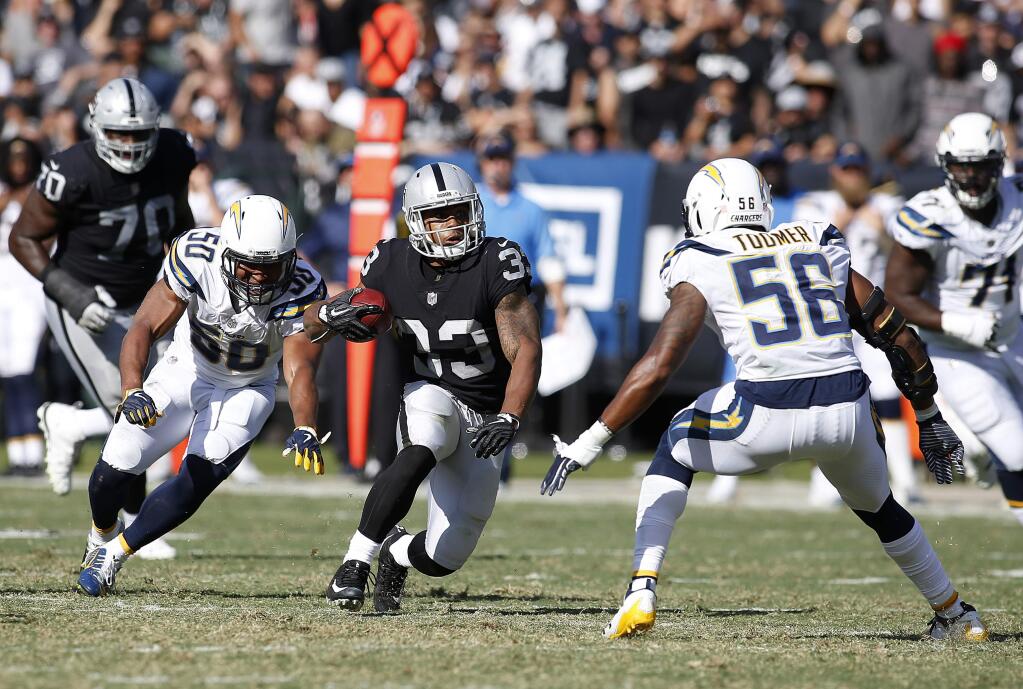 Oakland Raiders running back DeAndre Washington (33) runs against the Los Angeles Chargers during the second half of an NFL football game in Oakland, Calif., Sunday, Oct. 15, 2017. (AP Photo/D. Ross Cameron)