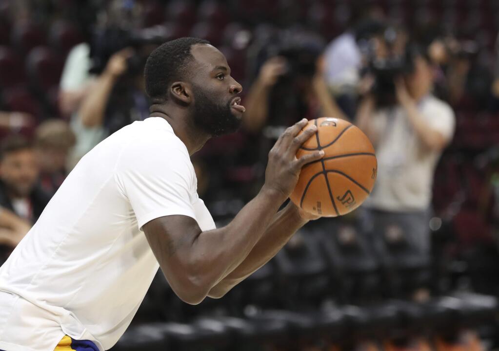 Golden State Warriors forward Draymond Green shoots as the team practiced during the NBA Finals, Wednesday, June 7, 2018, in Cleveland. The Warriors lead the series 3-0 with Game 4 on Friday. (AP Photo/Carlos Osorio)