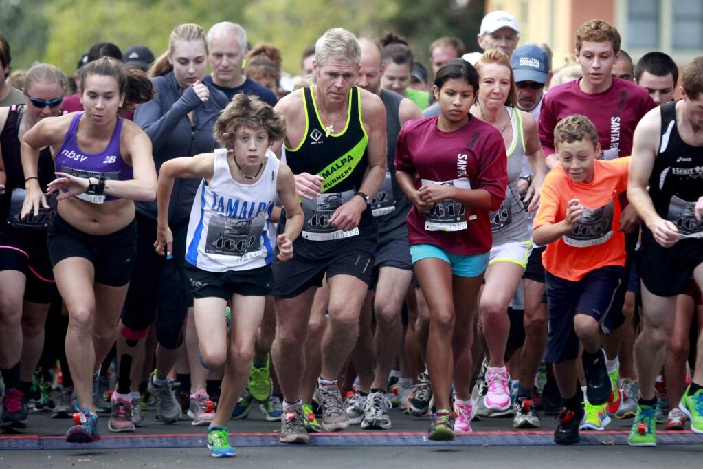Runners take off from the starting line during the 2013 Santa Rosa 5K on South A St. in Santa Rosa. (BETH SCHLANKER / The Press Democrat, file)