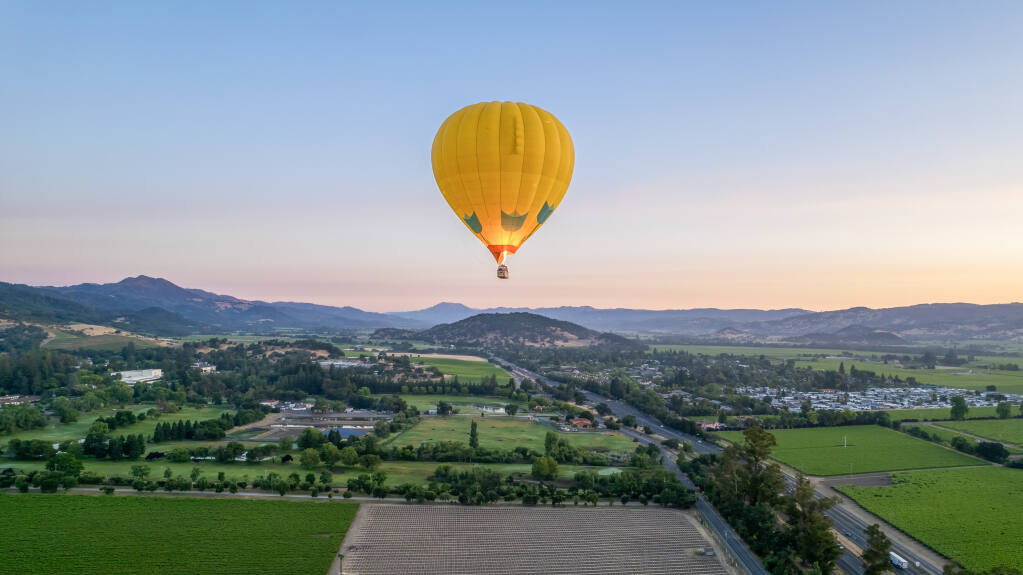 A pilot for a Napa Valley Balloons ignites the heater as the craft floats over the valley just before dawn June 21, 2023. (Courtesy: Napa Valley Balloons)