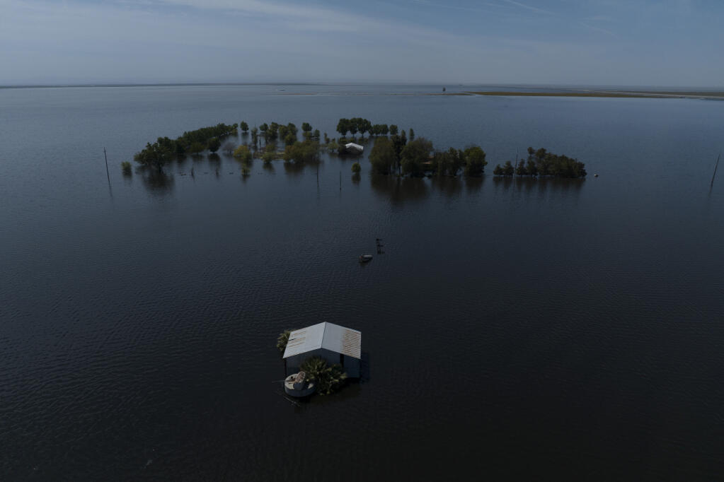FILE - Farmland in the Tulare Lake Basin is submerged in water in Corcoran, Calif., on Thursday, April 20, 2023. On Monday, May 22, 2023, California officials said communities near the Tulare Lake Basin were unlikely to flood this year. (AP Photo/Jae C. Hong,File)
