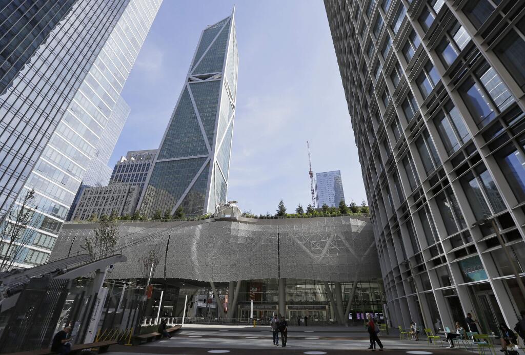 FILE - In this Sept. 27, 2018, file photo, a few people walk through main plaza entryway to the closed Salesforce Transit Center in San Francisco. (AP Photo/Eric Risberg, File)
