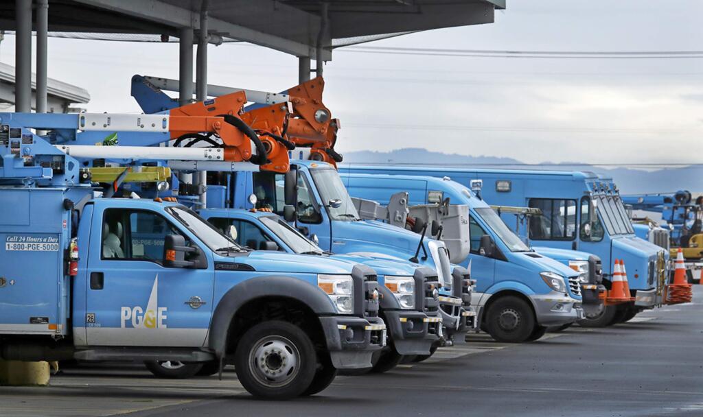 FILE - This Jan. 14, 2019, file photo shows Pacific Gas & Electric vehicles parked at the PG&E Oakland Service Center in Oakland, Calif. A decision was announced Friday, May 1, 2020, that Pacific Gas & Electric Corp. will sweep out three quarters of its board of directors to start with a mostly clean slate when it emerges from a bankruptcy case triggered by deadly wildfires ignited in Northern California by the utility's neglected electrical grid. (AP Photo/Ben Margot, File)