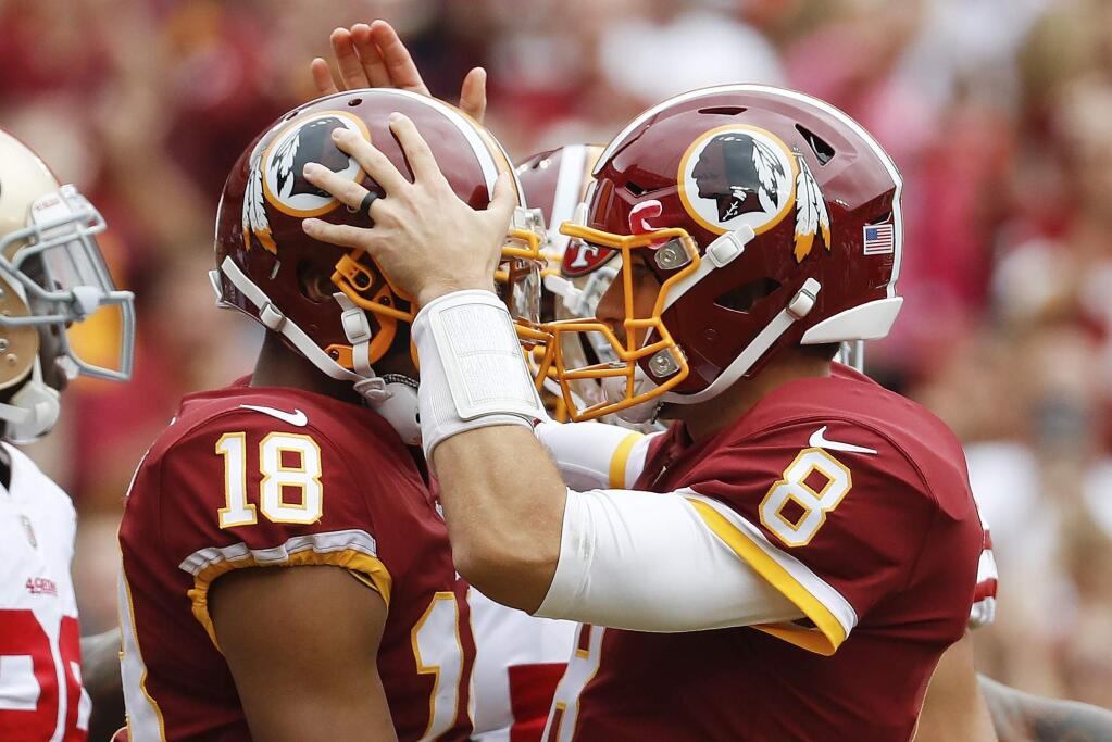 Washington Redskins quarterback Kirk Cousins (8) congratulates wide receiver Josh Doctson (18) after a touchdown during the first half of an NFL football game against the San Francisco 49ers in Landover, Md., Sunday, Oct. 15, 2017. (AP Photo/Alex Brandon)