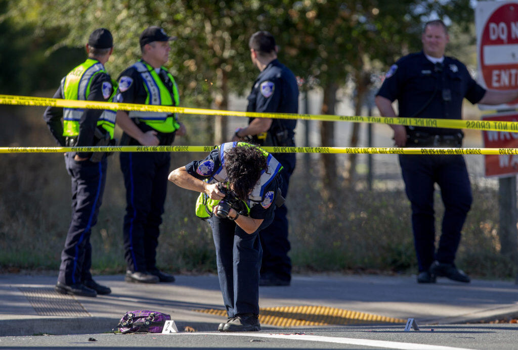 Santa Rosa Police crime scene investigator photographs a bag at the scene of a fatal bike vs. debris truck accident on Stony Point Rd. at the Joe Rodota trail crossing on Tuesday afternoon.   (photo by John Burgess/The Press Democrat)